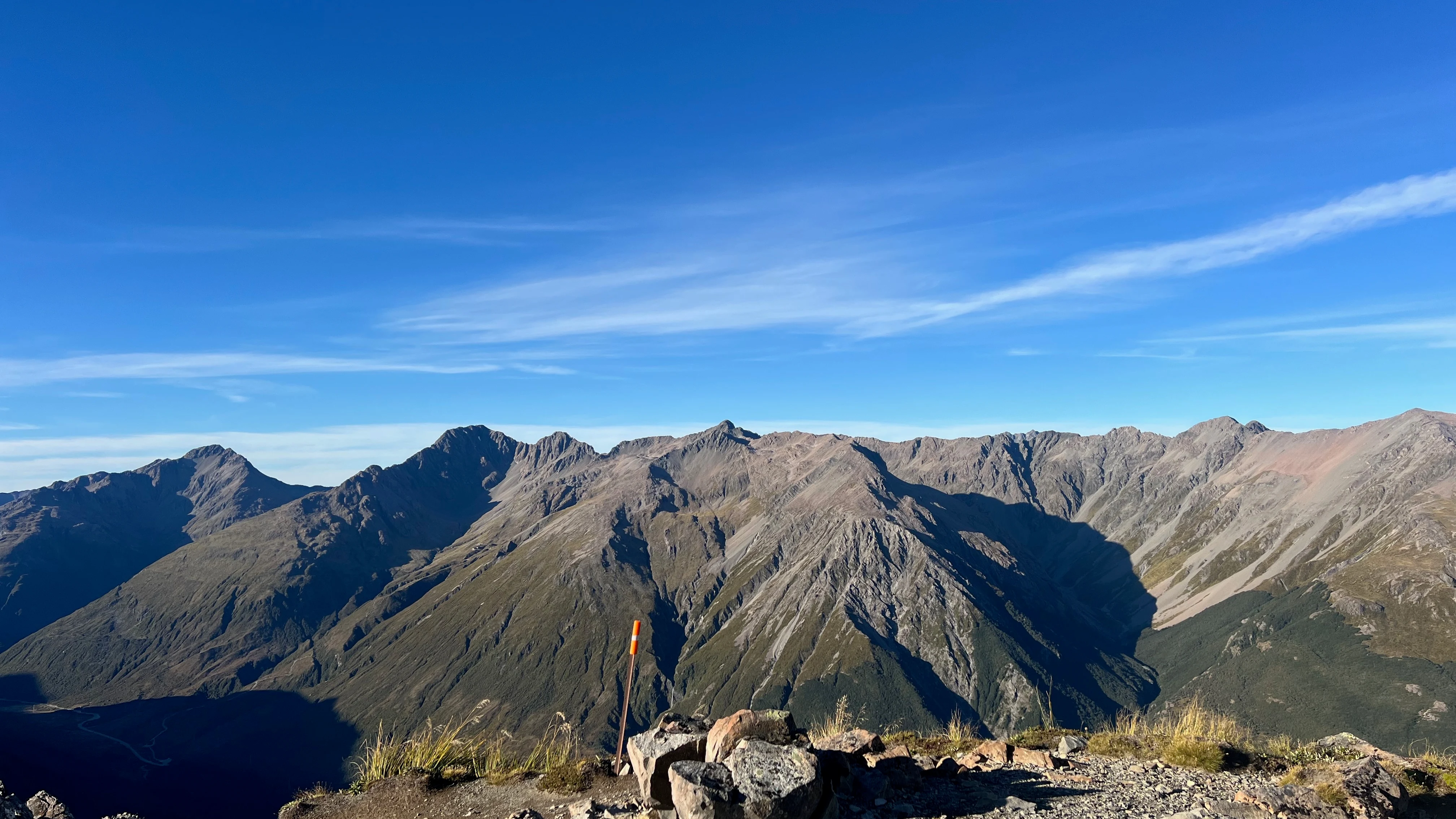 A panorama of jagged peaks from a stony ridge in Arthur's Pass.