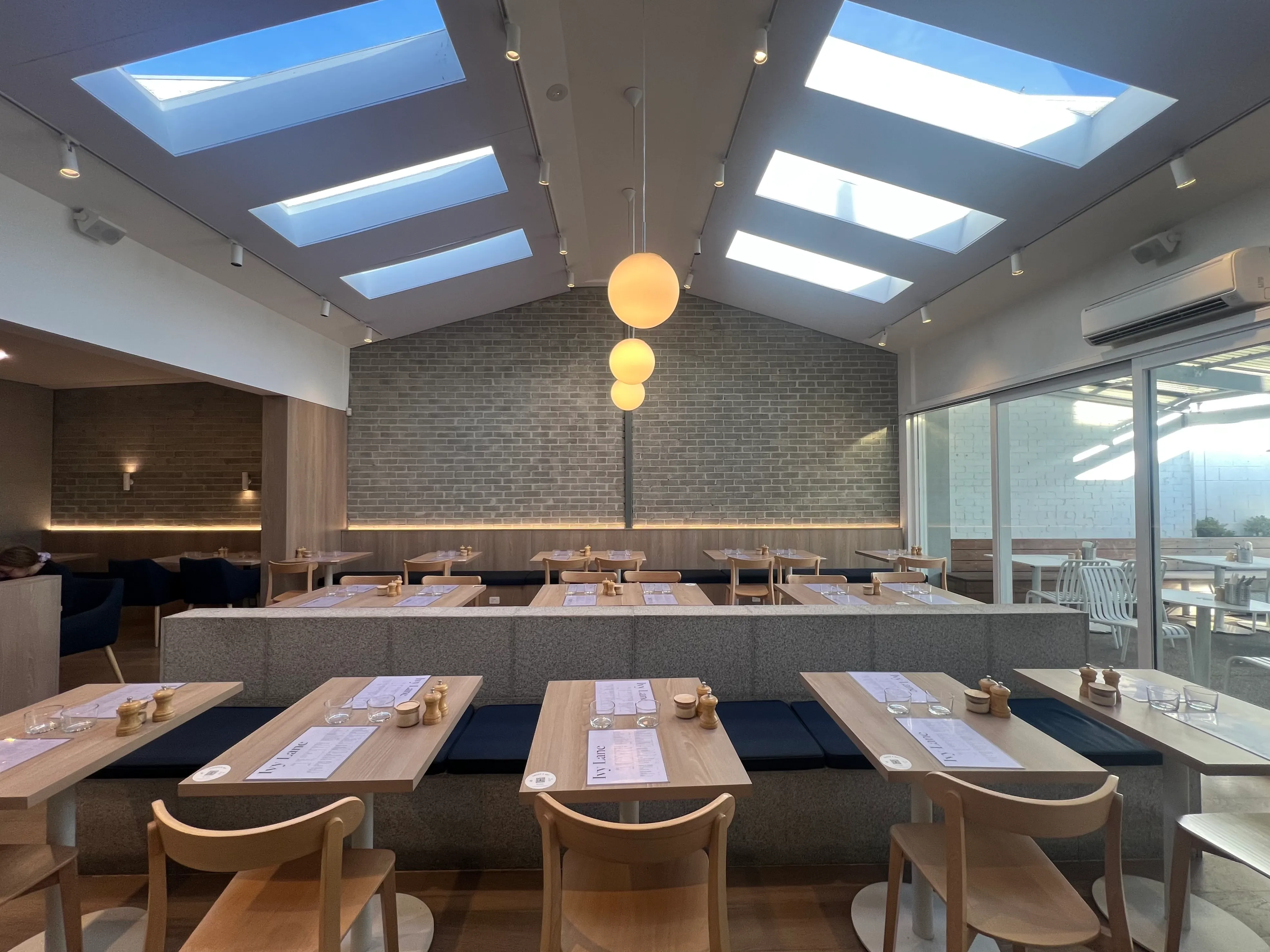 A bright café interior lit by skylights.