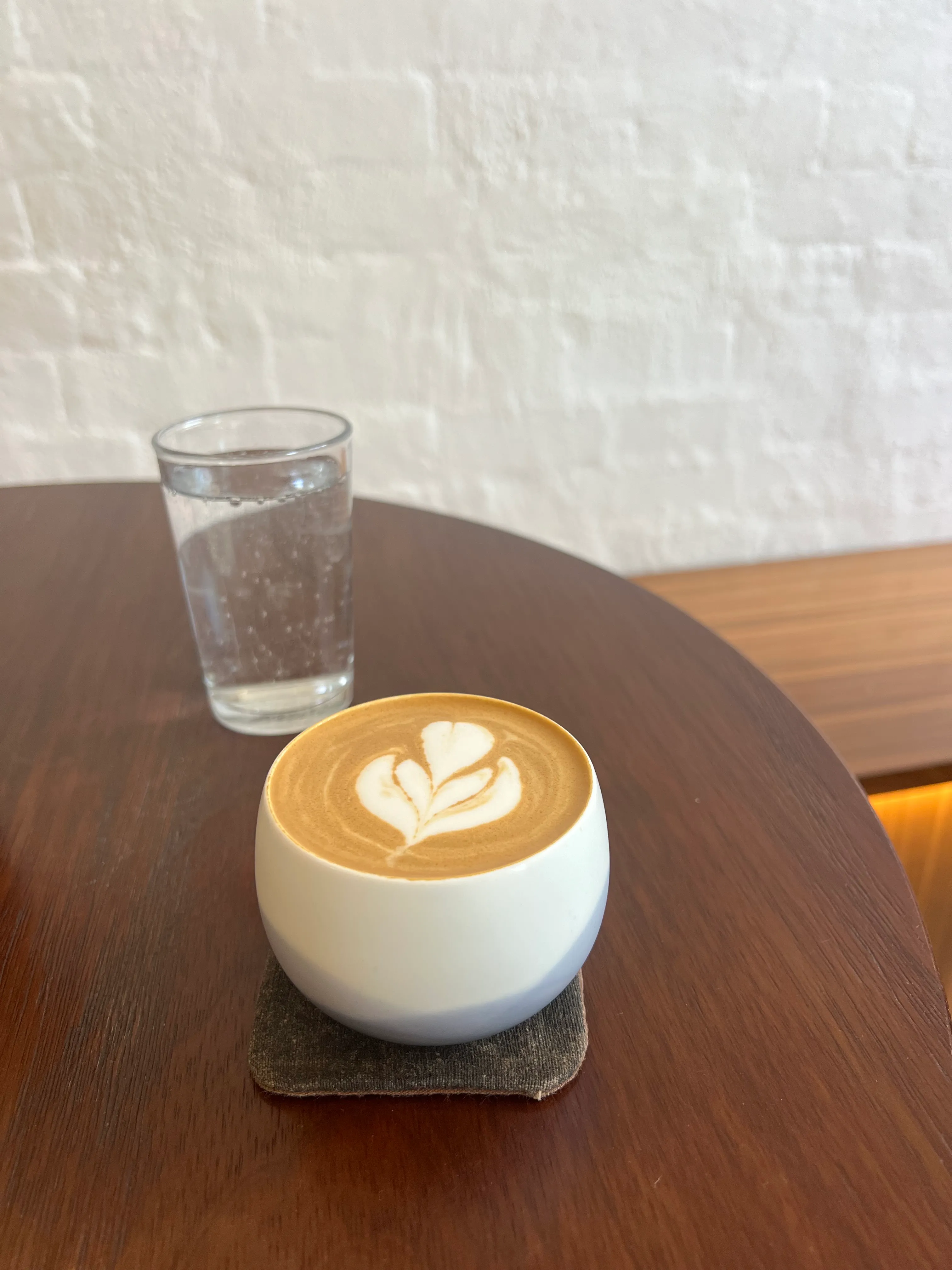 A latte on a wooden table.