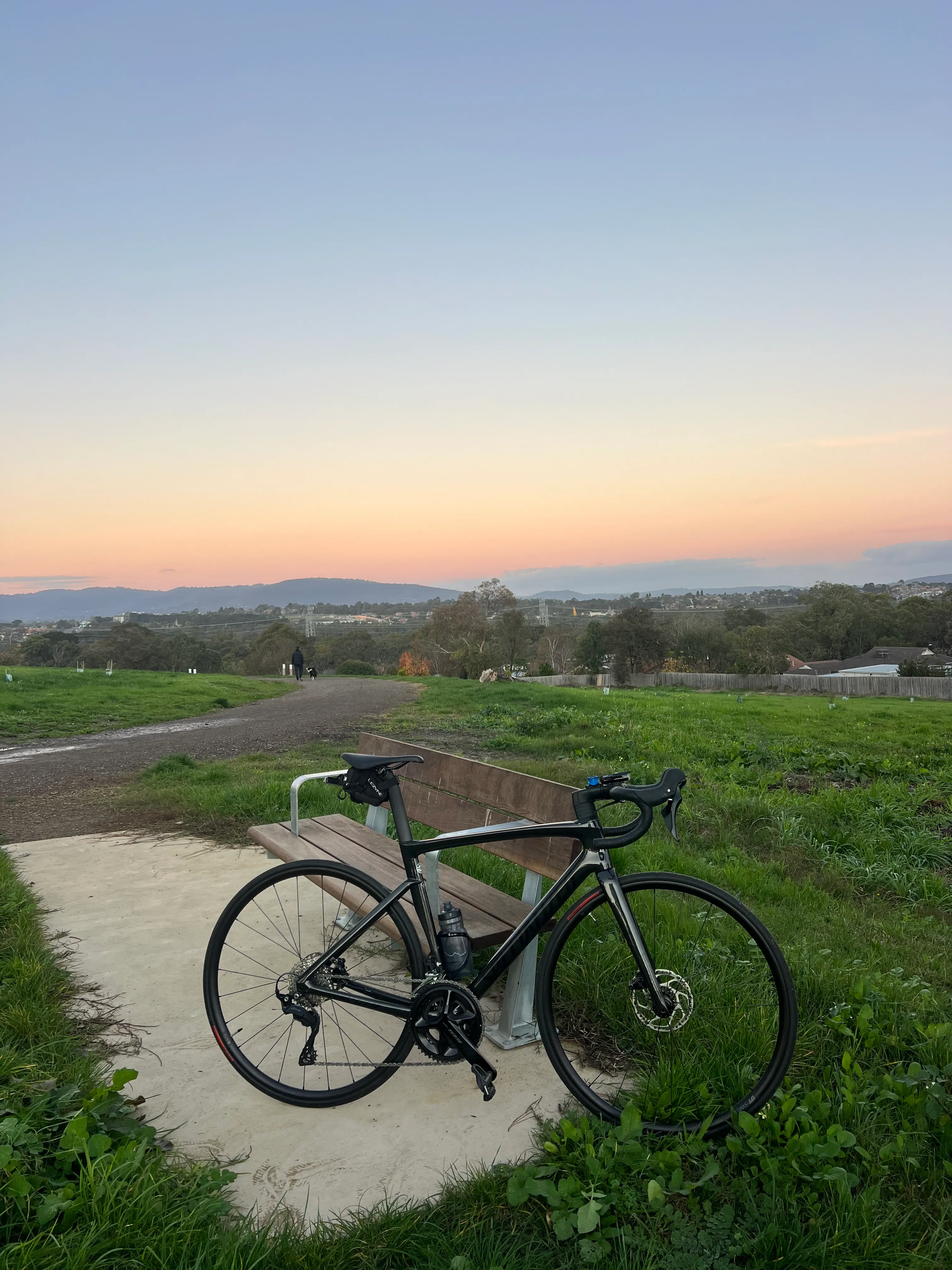 A bike on a hilltop at sunset.