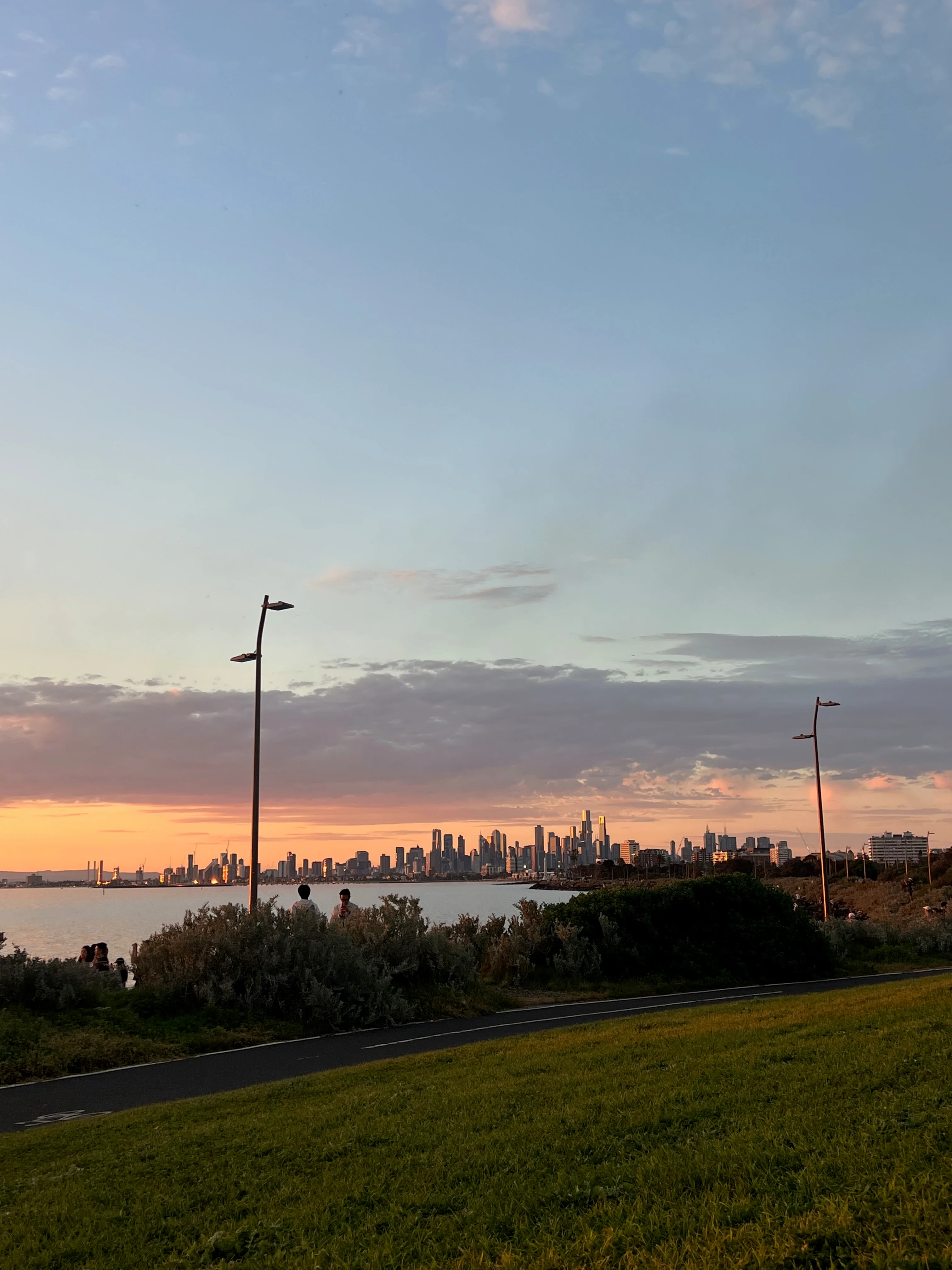 Melbourne skyline across the bay at sunset.