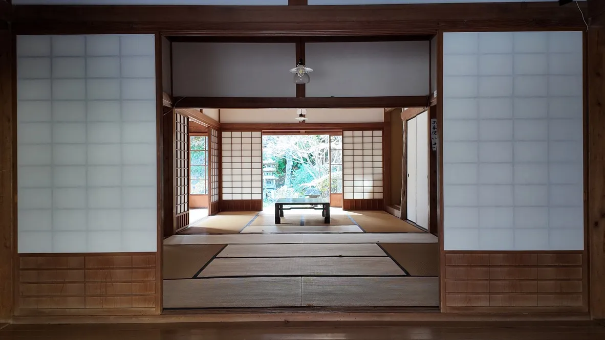 Tatami rooms framed by wooden beams and sliding paper screens.